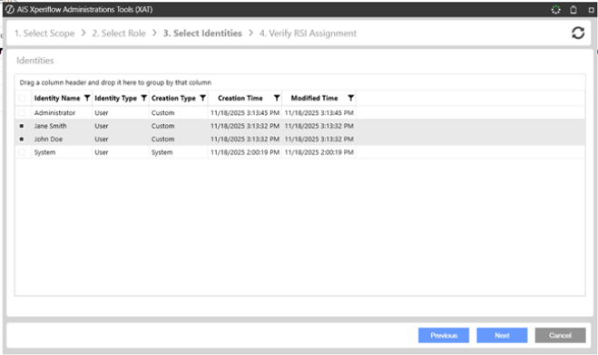 AIS Xperiflow Administration Tools assignment wizard (Step 3: Select Identities) showing a table of available identities (e.g., Administrator, Jane Smith, John Doe, System) with columns for identity type, creation type, and timestamps, along with Previous, Next, and Cancel buttons